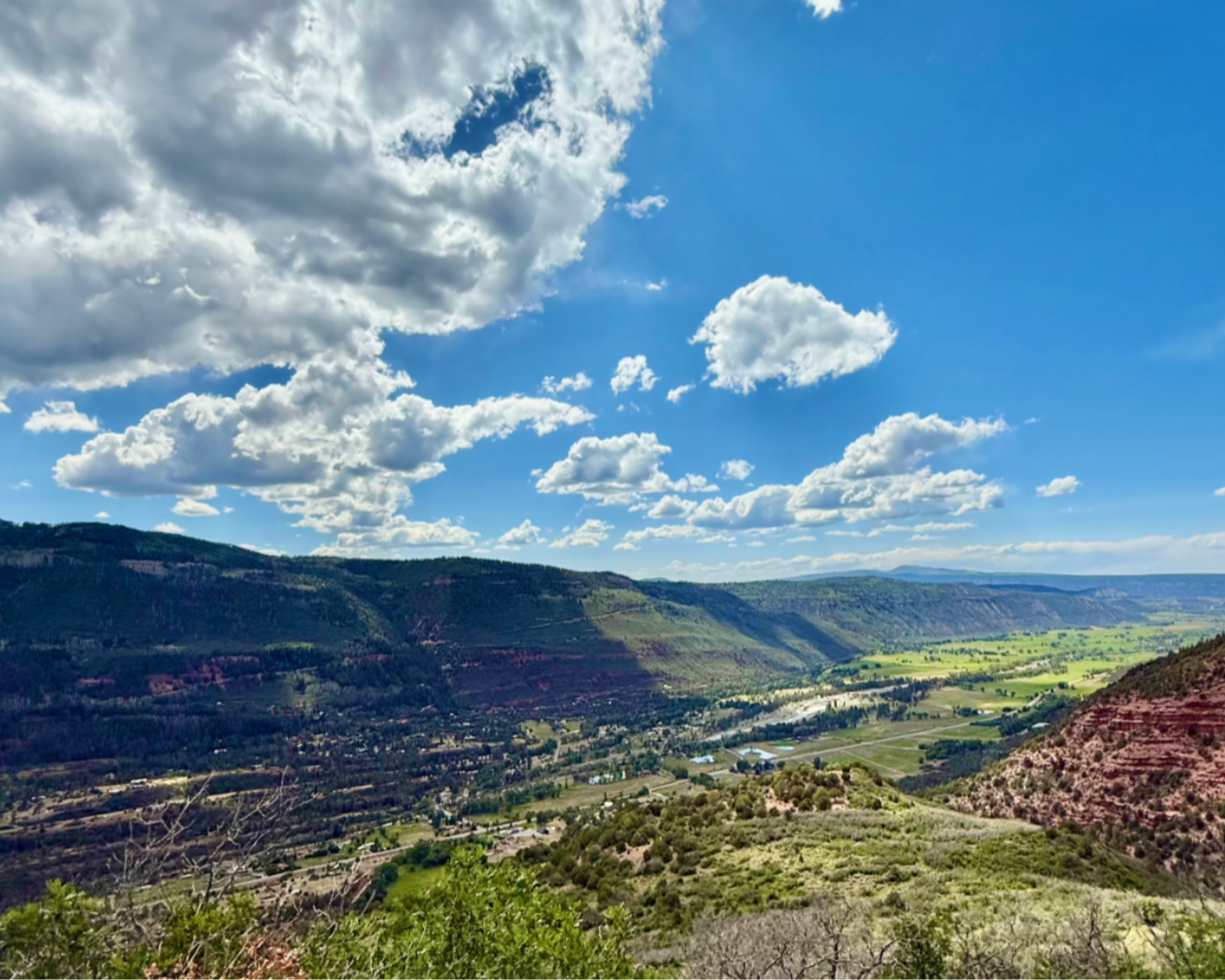 green valley surrounded by red rock