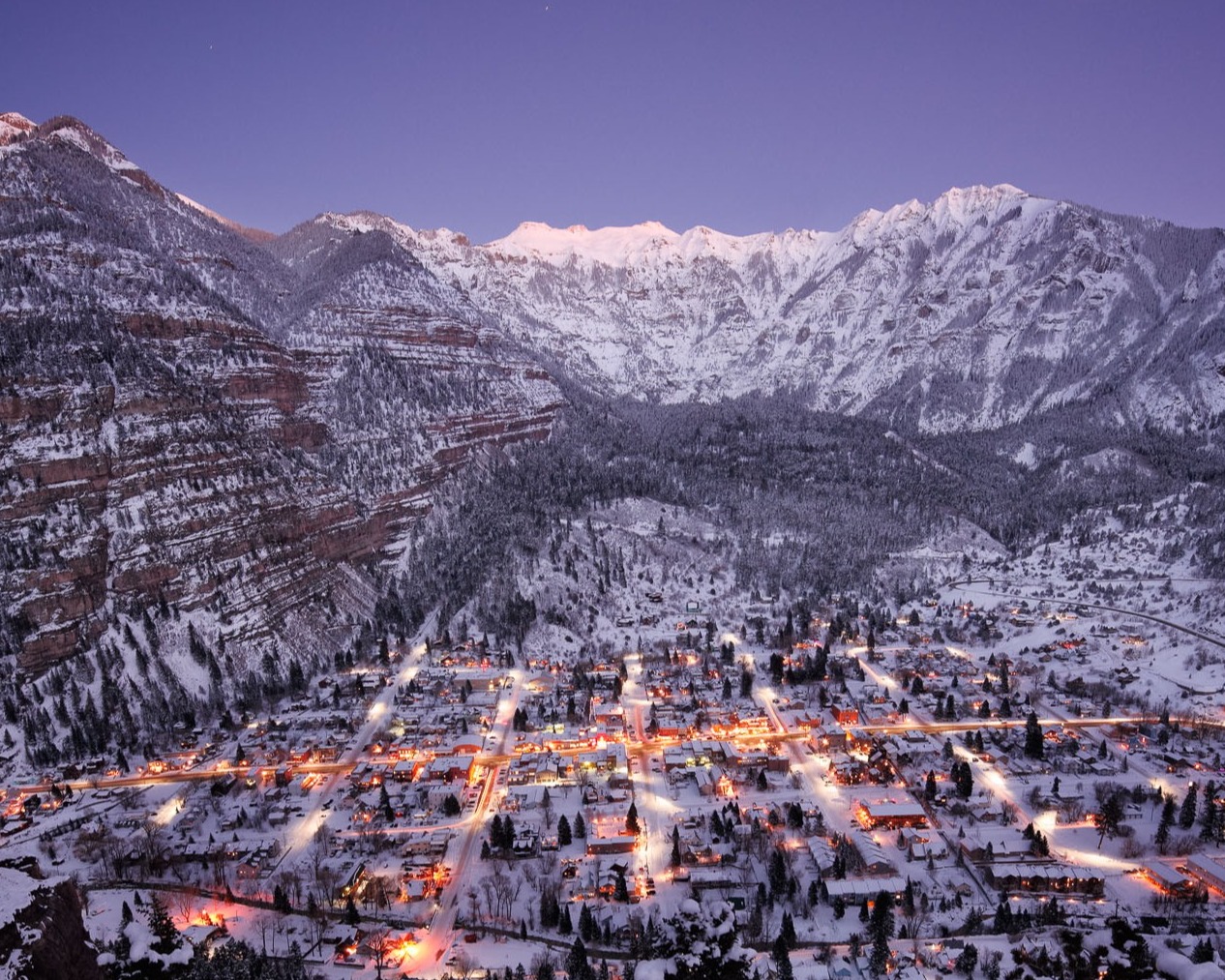snowy town lit up by lights