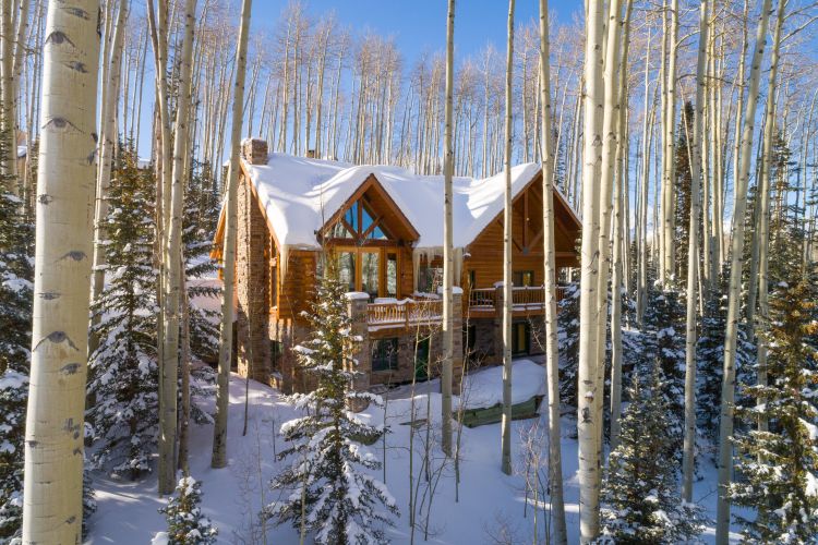 log mansion covered in snow in the mountain forest