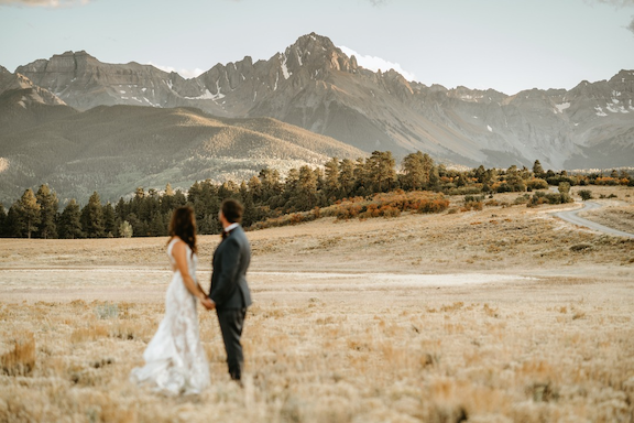 Bride and groom looking at Mt. Sneffels